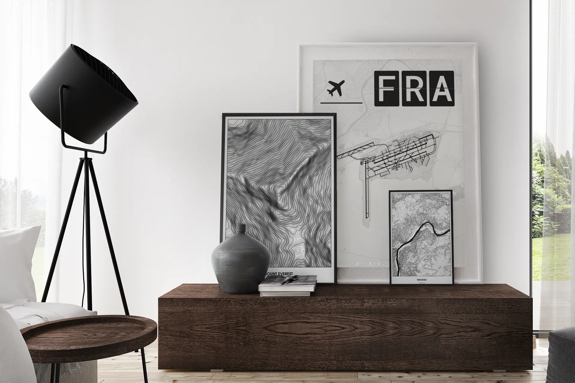 Three art prints of different sizes displayed on a living-room wall, demonstrating how the collection scales into interiors